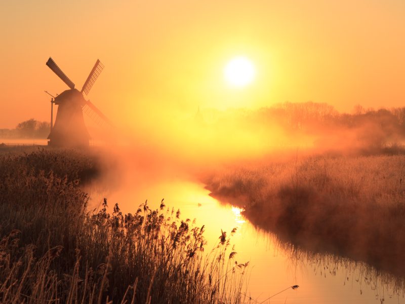 Dutch,Sunrise,With,Traditional,Windmill,And,A,Canal,In,The
