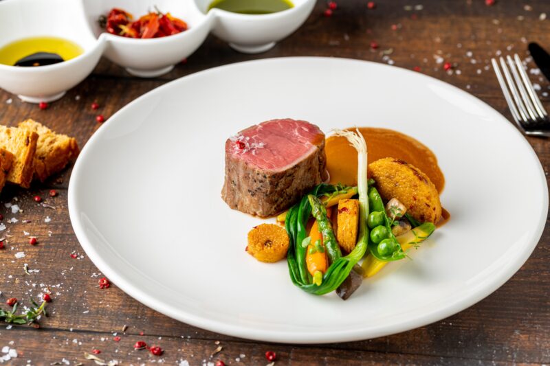 Filet,Mignon,Served,With,Vegetables,And,Sauces,At,A,Fine