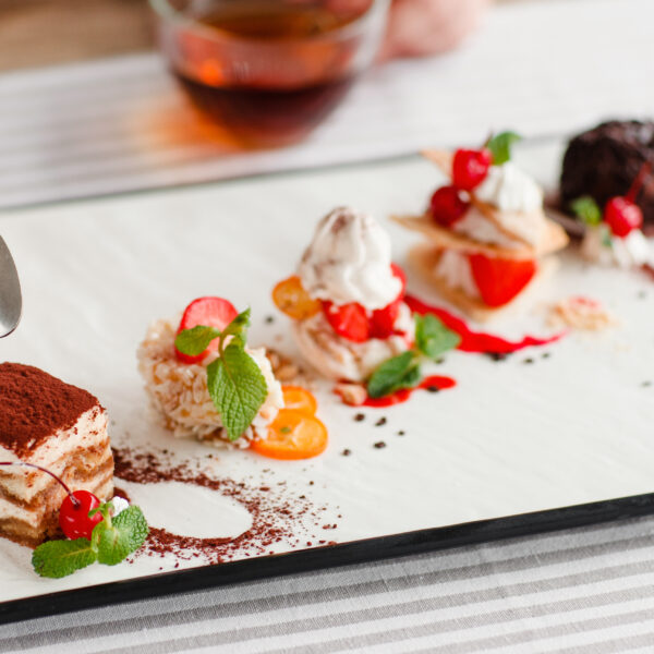 Tasting,One,Cake,From,Lots,,Close up.,Plate,With,Five,Different