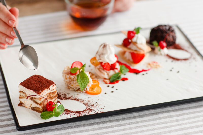 Tasting,One,Cake,From,Lots,,Close up.,Plate,With,Five,Different